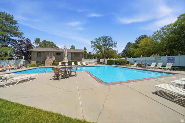6969 South 855 East Midvale, UT 84047 - Photo 51 of 55 Expansive outdoor swimming pool with a surrounding concrete deck, providing ample space for outdoor activities