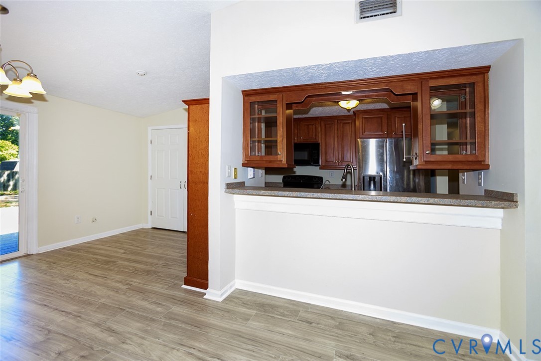 925 Fluvanna Road Newport News, VA 23601 - Photo 5 of 25 a view of living room and kitchen with wooden floor