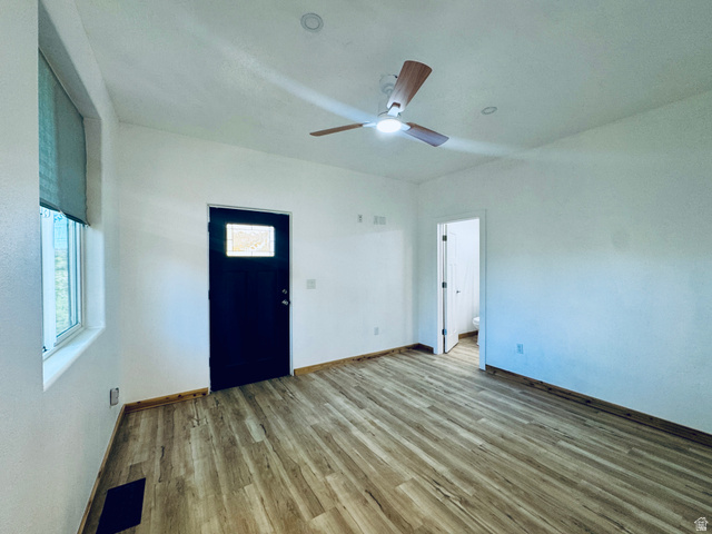 150 North 3050 East, Unit 4 St. George, UT 84790 - Photo 17 of 24 Spacious room featuring wood-finish flooring, a contemporary ceiling fan with integrated lighting, recessed ceiling lights, and a window with a roller shade