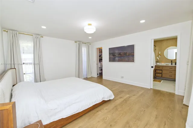 a large bedroom with a bed and a view of bedroom