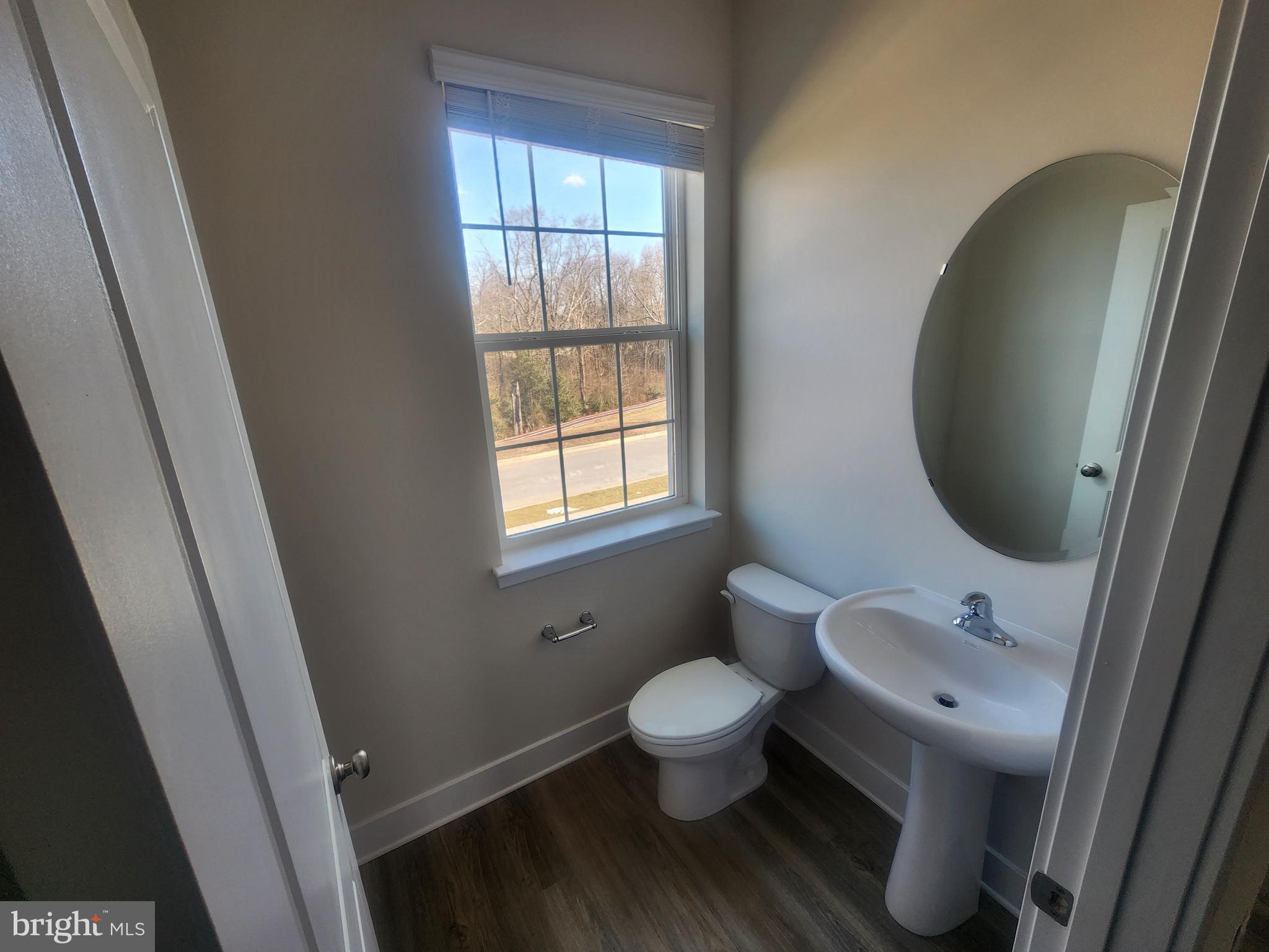 231 Joppa Farm Road Joppa, MD 21085 - Photo 18 of 25 a bathroom with a toilet sink and a mirror