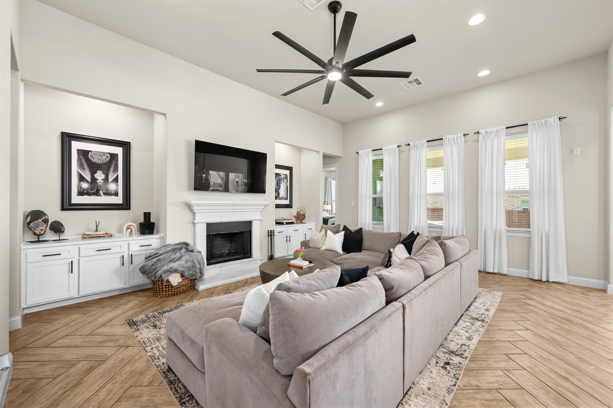 2100 Highland Ridge Road Georgetown, TX 78628 - Photo 7 of 30 A spacious living room features warm wood flooring and a classic fireplace.