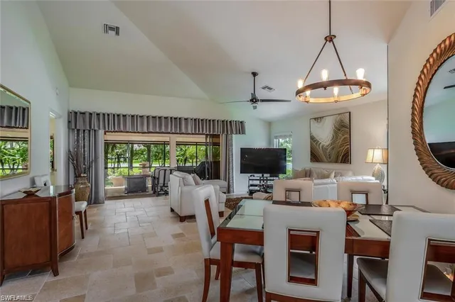 a living room with furniture a flat screen tv and a large window