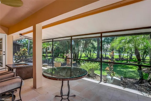a view of a porch with furniture and backyard
