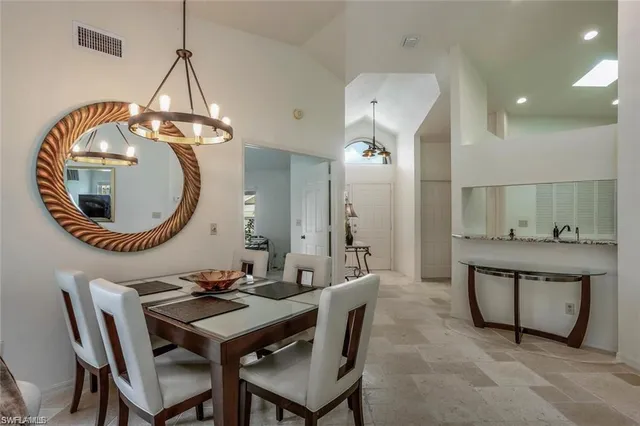 a dining room with a table and chairs