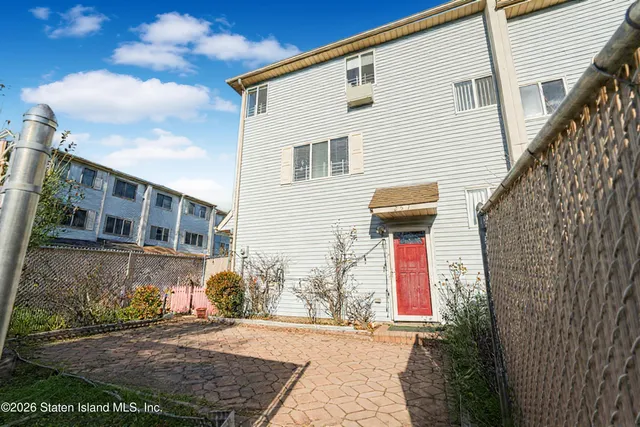 a view of a house with wooden fence