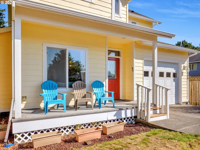 a view of front door of house with outdoor seating
