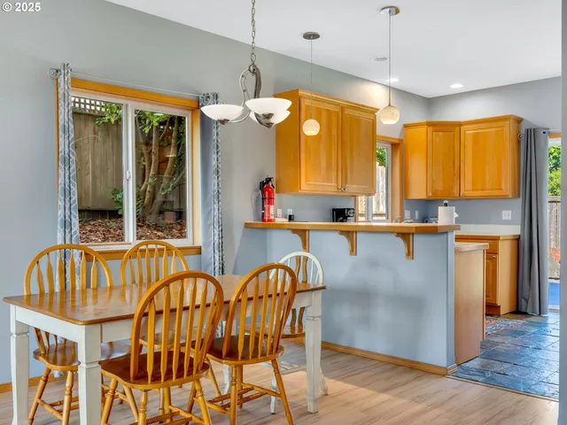 a view of kitchen with granite countertop a window and a view of dining room