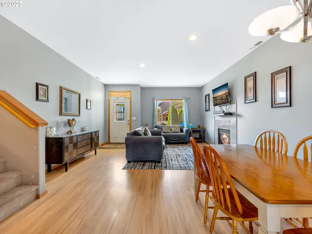 a living room with fireplace furniture and a wooden floor