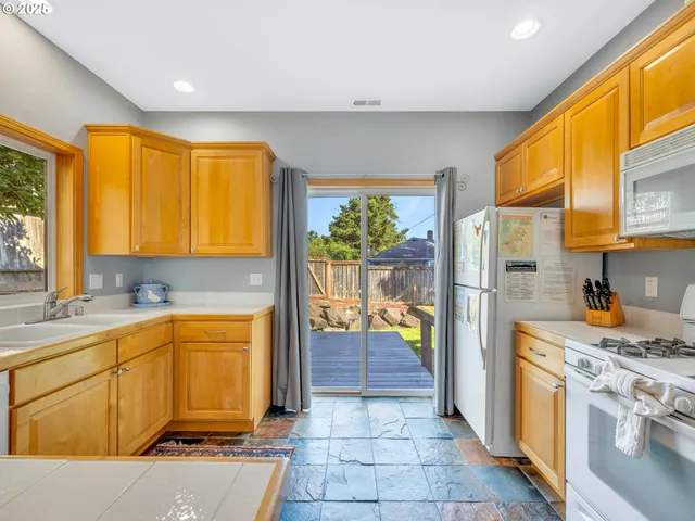 a kitchen with a sink and refrigerator