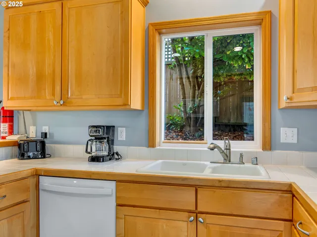 a kitchen with stainless steel appliances a sink and a window