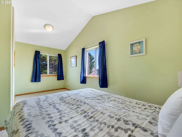 a bedroom with a bed and painting on the wall