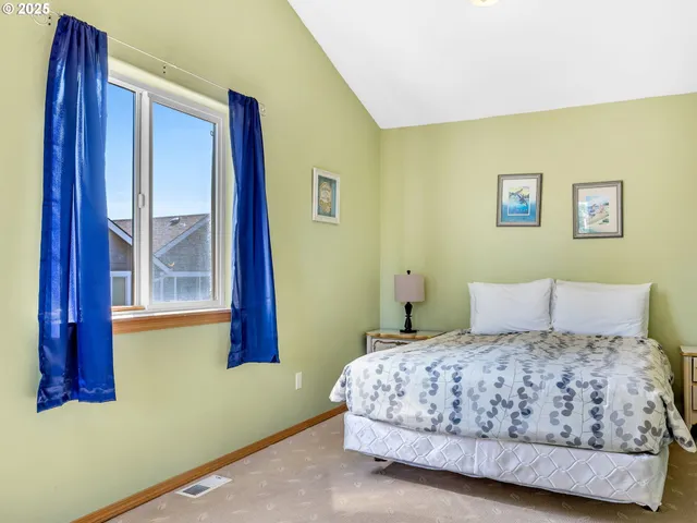 a bedroom with a bed and a painting on the wall