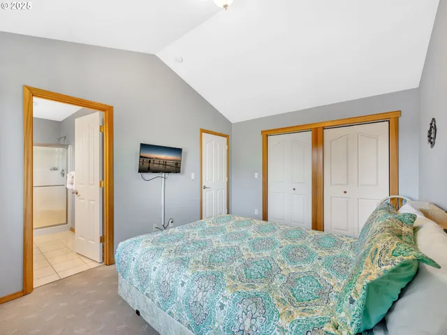 a bedroom with a bed and a painting