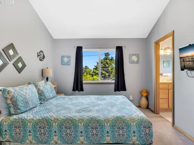 a bedroom with a bed and ceiling fan