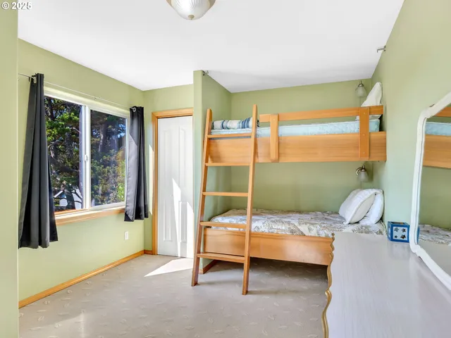 a bedroom with a bed and large glass window