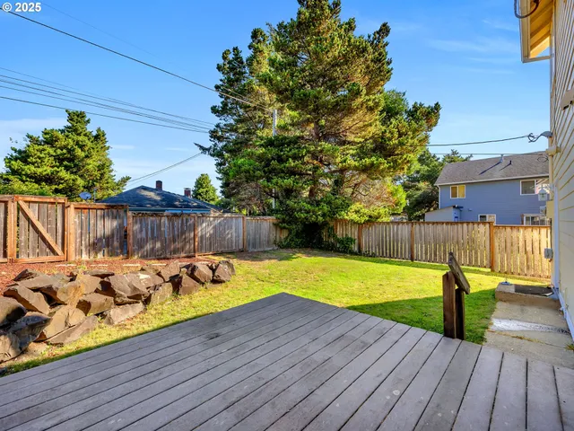 a view of a backyard with wooden fence