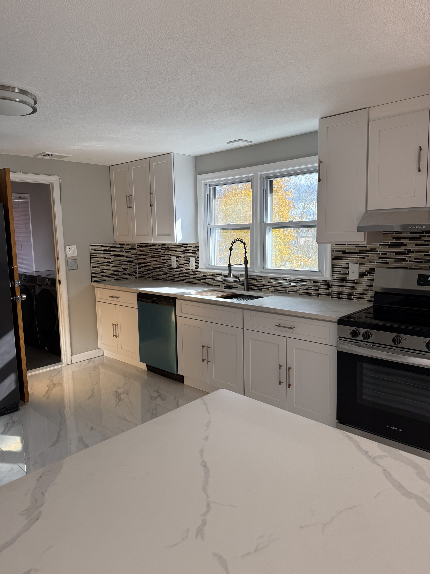 a kitchen with stainless steel appliances granite countertop a stove sink and cabinets