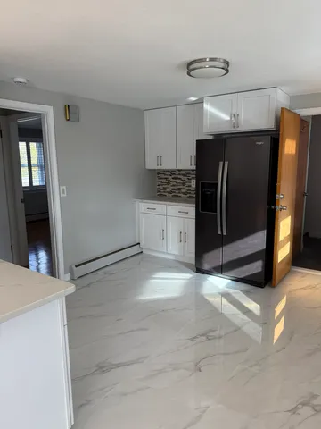 a view of a kitchen with refrigerator and microwave