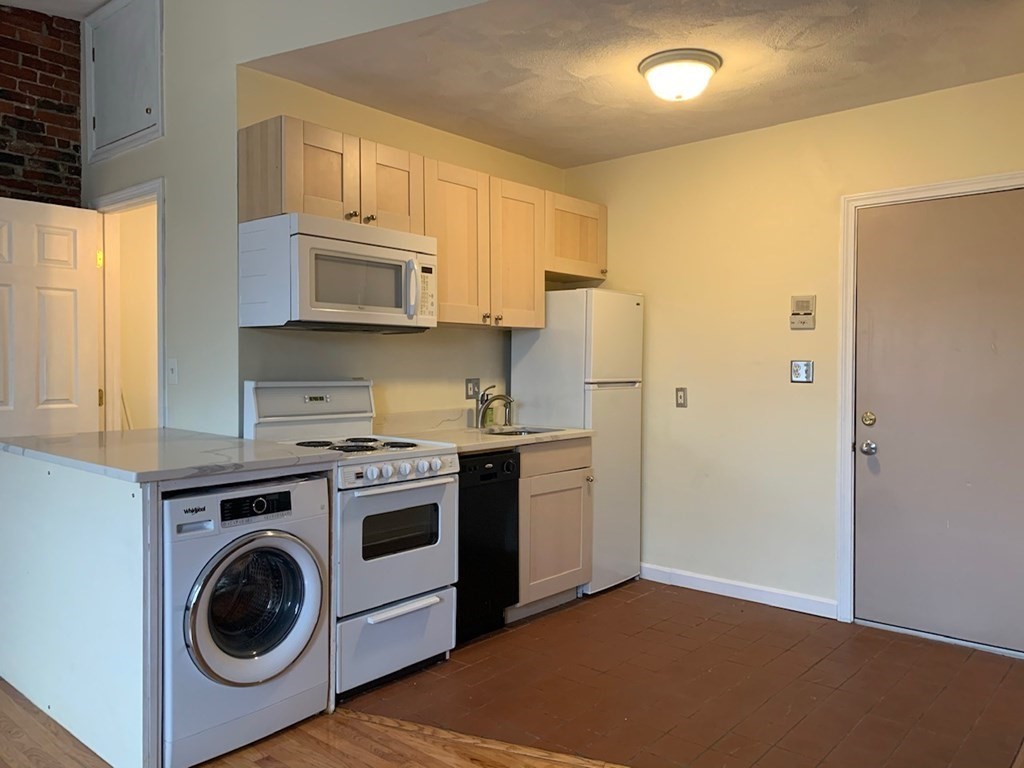 a utility room with sink dryer and washer