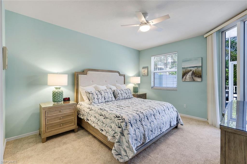 460 Launch Circle, Unit 202 Naples, FL 34108 - Photo 12 of 34 a bedroom with a bed a window and closet
