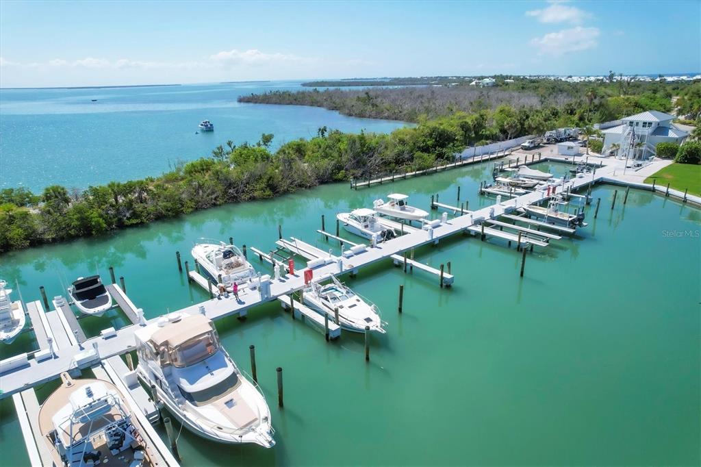 5820 Gasparilla Road, Unit SLIP #49 Boca Grande, FL 33921 - Photo 13 of 18 a view of a table and chairs on the deck