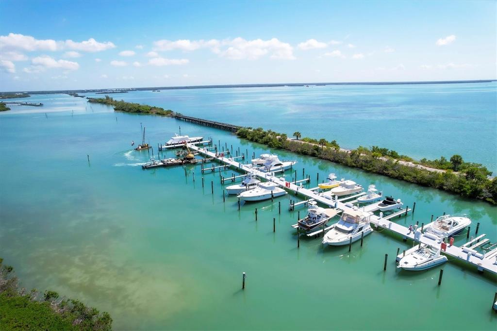5820 Gasparilla Road, Unit SLIP #49 Boca Grande, FL 33921 - Photo 14 of 18 a view of a lake with boats and trees in the background