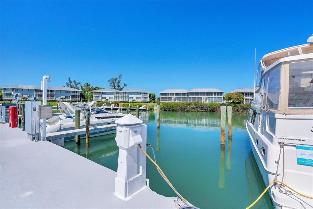 5820 Gasparilla Road, Unit SLIP #49 Boca Grande, FL 33921 - Photo 8 of 18 a view of a lake with a house