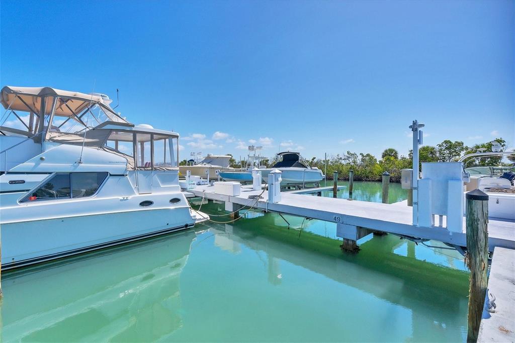 5820 Gasparilla Road, Unit SLIP #49 Boca Grande, FL 33921 - Photo 9 of 18 a view of a lake with a house swimming pool and outdoor space