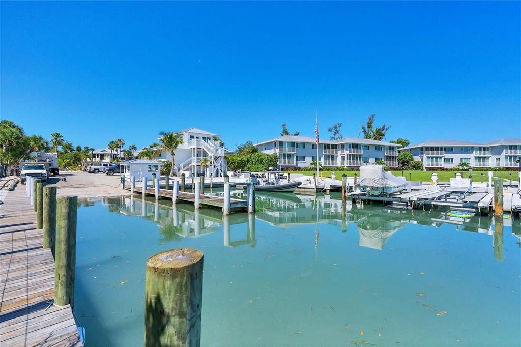 5820 Gasparilla Road, Unit SLIP #49 Boca Grande, FL 33921 - Photo 10 of 18 a view of a lake with boats and trees around