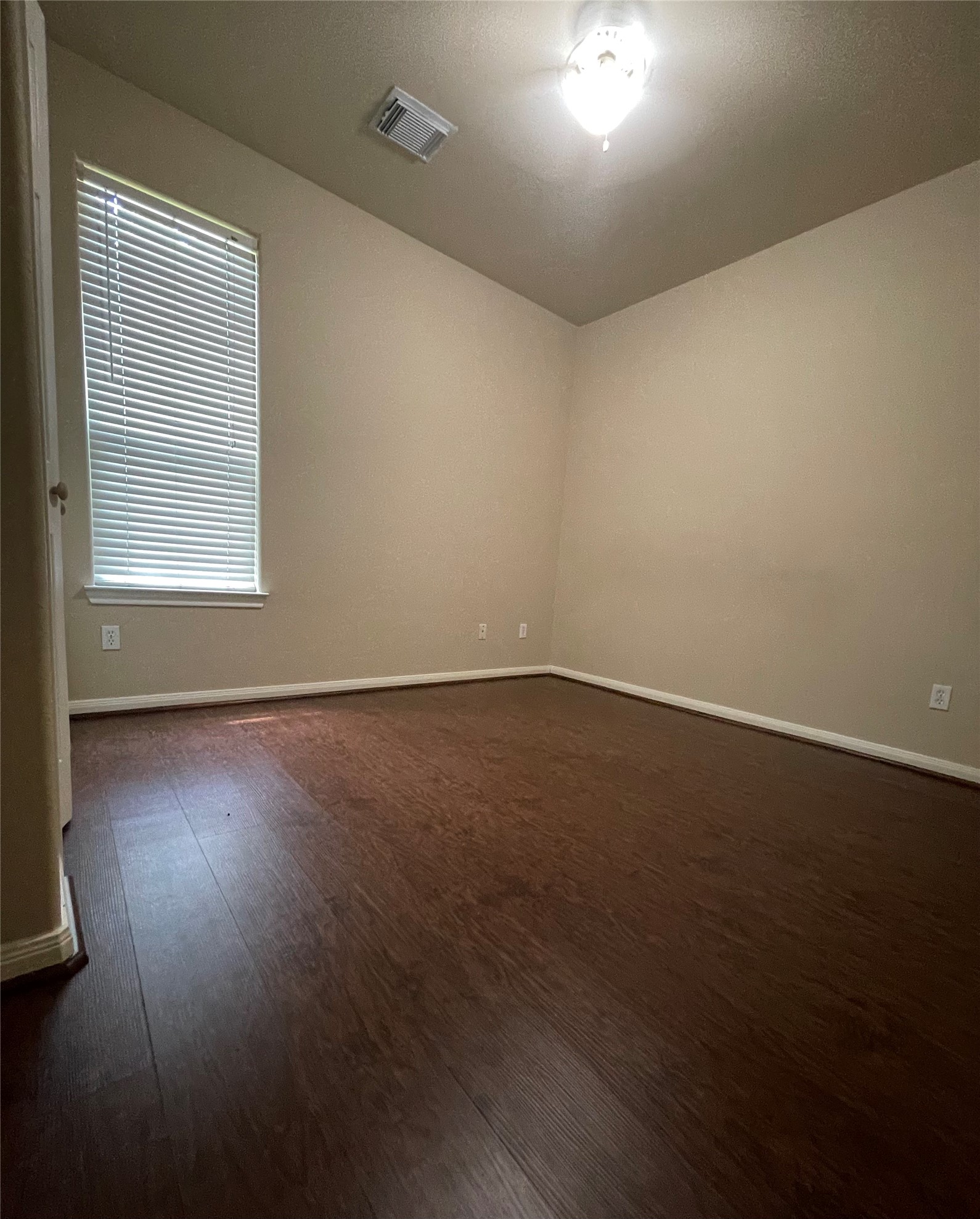 10607 Mills Way Houston, TX 77070 - Photo 13 of 17 an empty room with wooden floor and windows