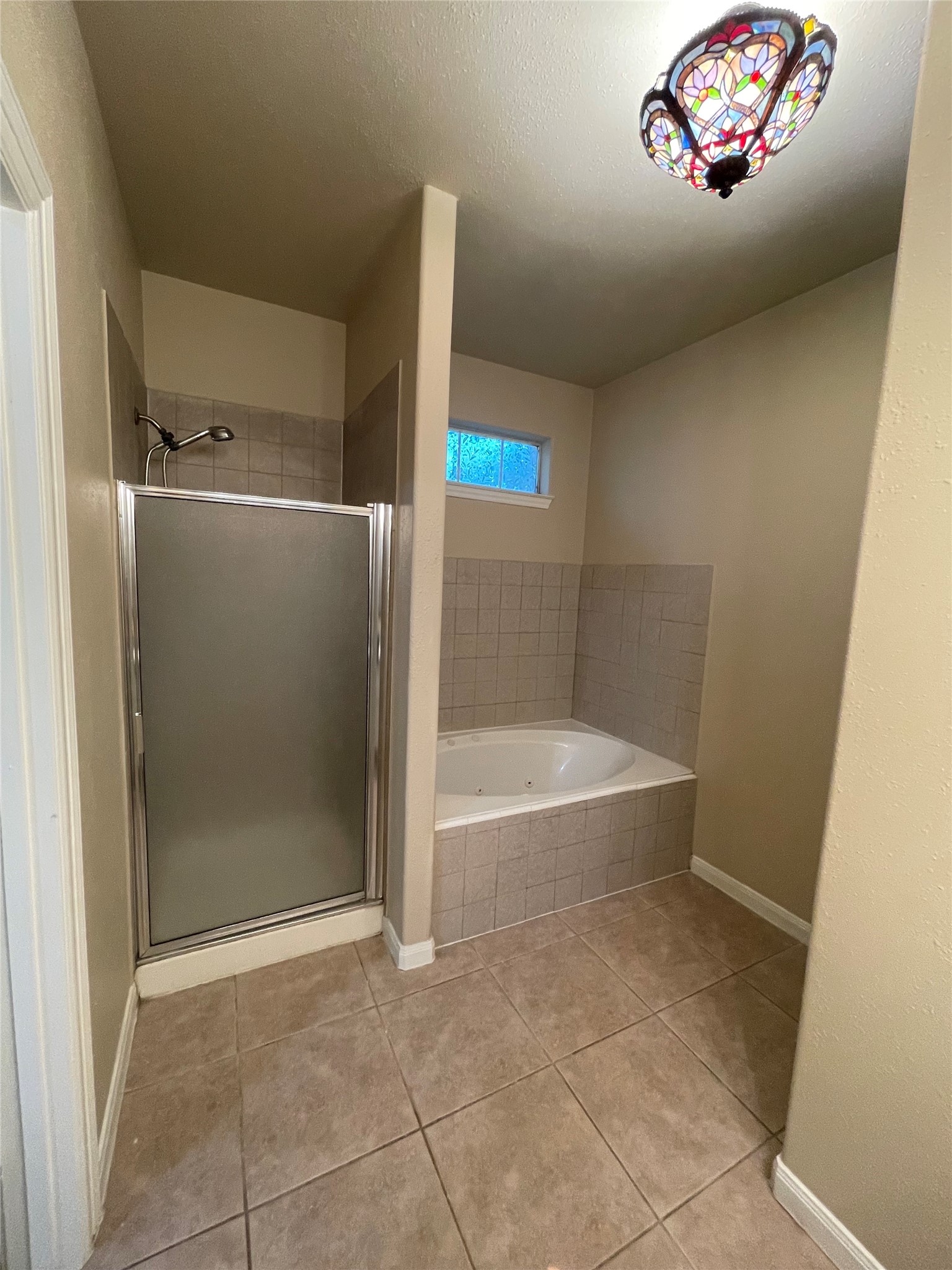 10607 Mills Way Houston, TX 77070 - Photo 14 of 17 a bathroom with a tub and a shower
