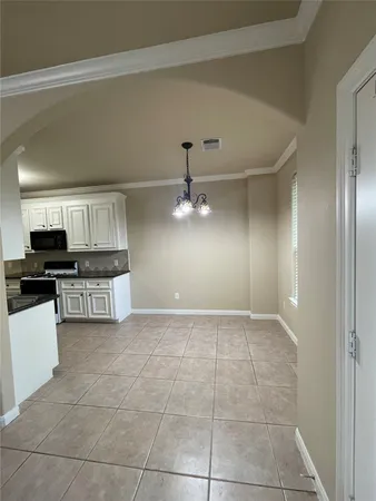 a kitchen with kitchen island granite countertop a stove top oven a sink a counter top space and cabinets