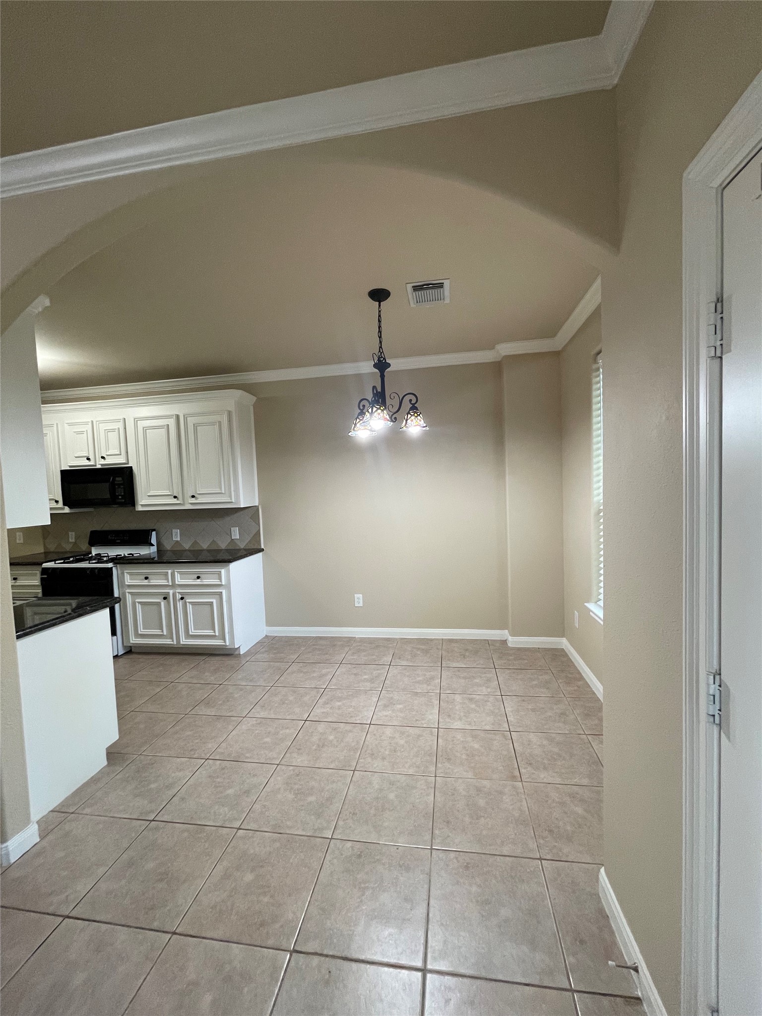 10607 Mills Way Houston, TX 77070 - Photo 5 of 17 a kitchen with kitchen island granite countertop a stove top oven a sink a counter top space and cabinets