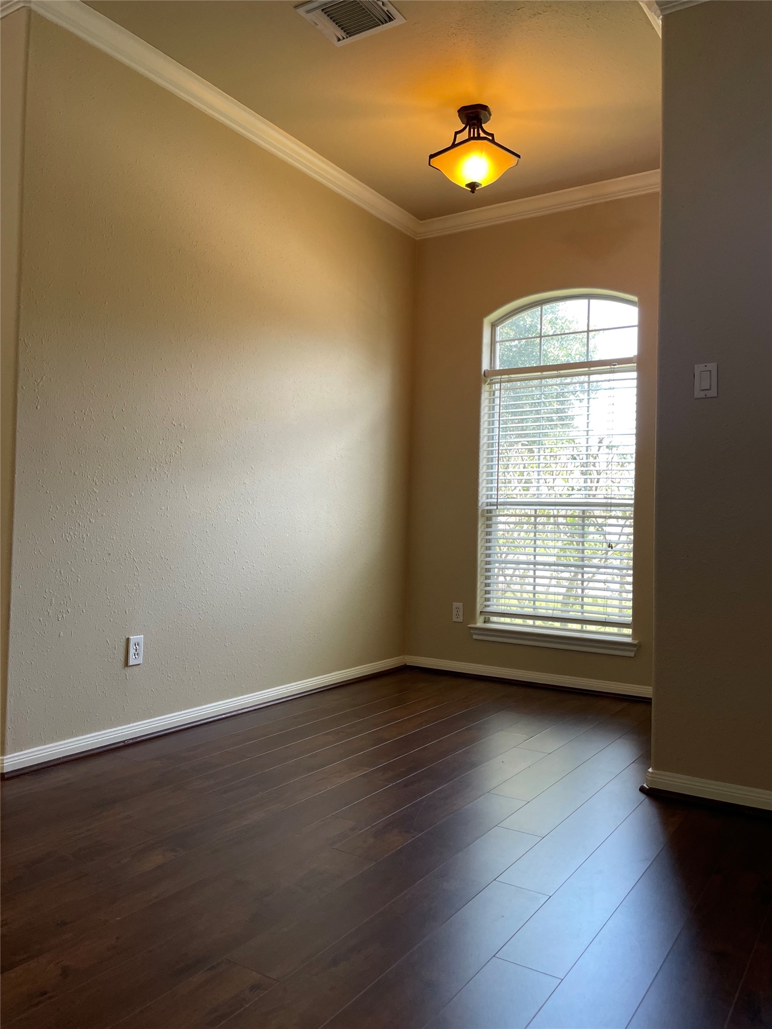 10607 Mills Way Houston, TX 77070 - Photo 8 of 17 an empty room with wooden floor and windows