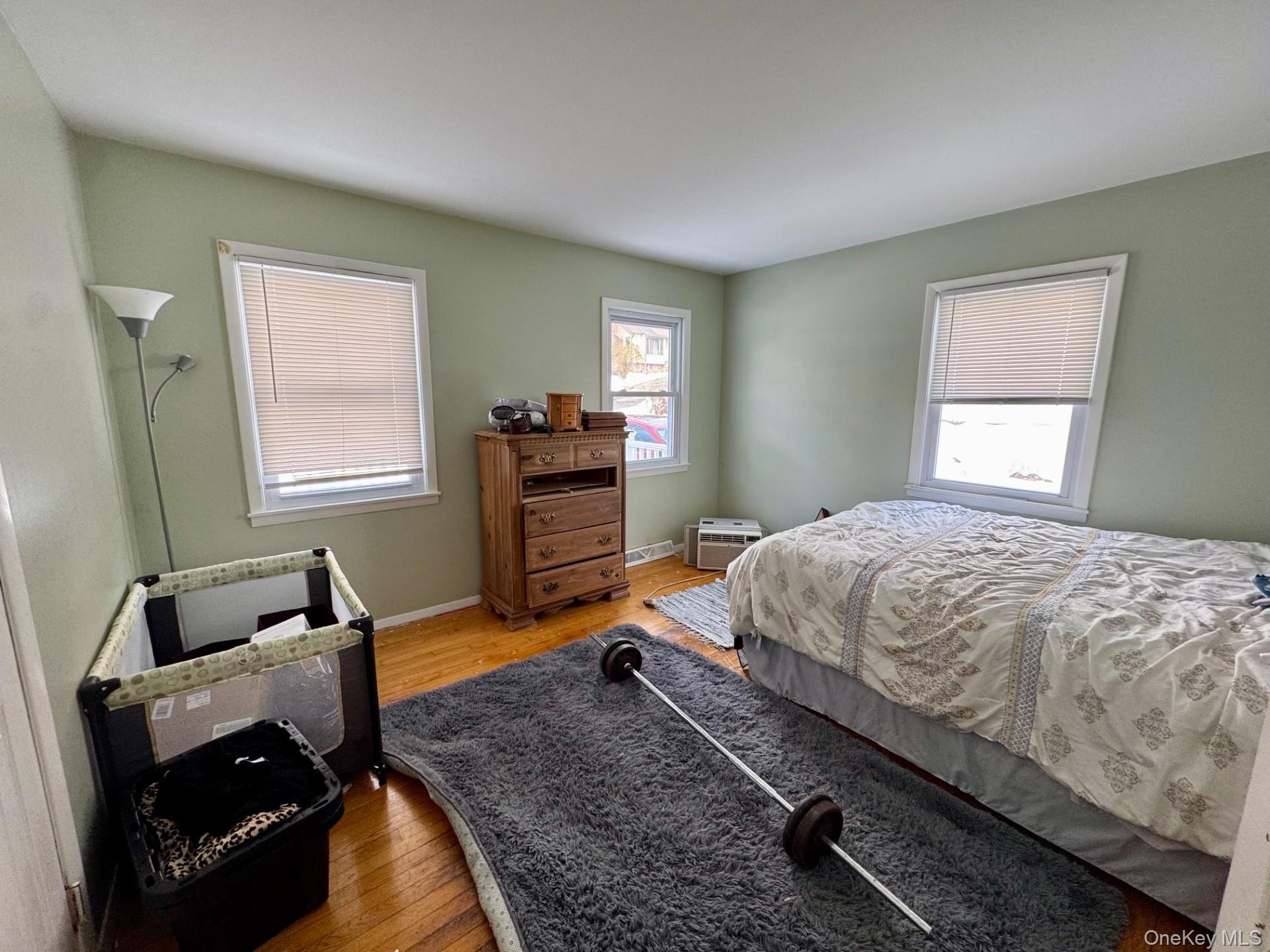 10 Maplewood Road Highland Mills, NY 10930 - Photo 5 of 9 a bedroom with a bed and wooden floor