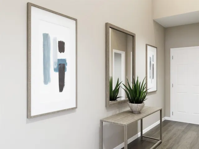 a living room with stainless steel appliances kitchen island granite countertop a dining table chairs and a refrigerator