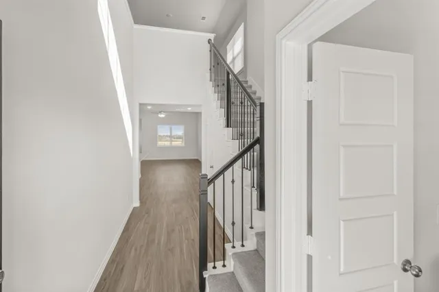 a view of a hallway with wooden floor and entryway
