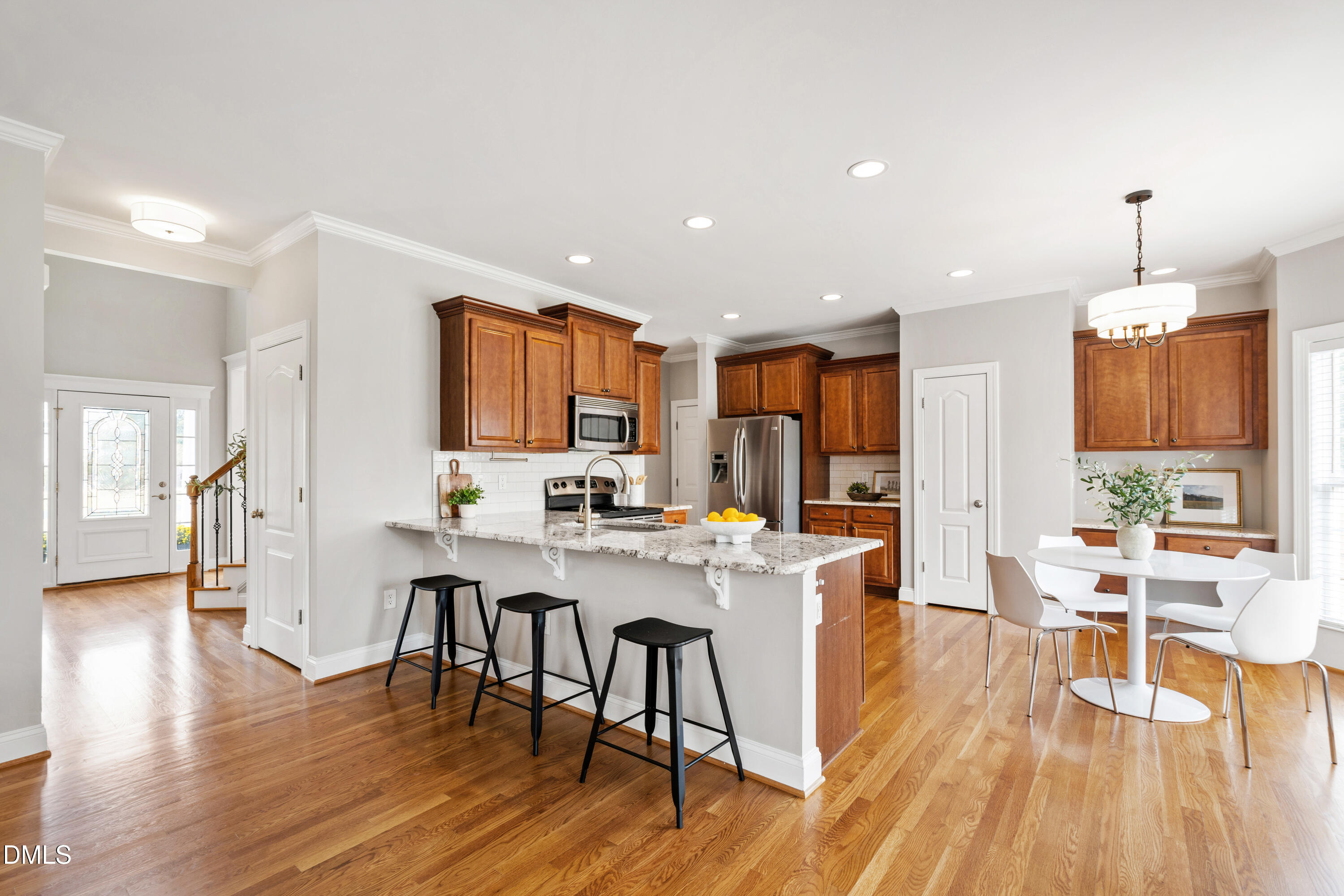 7753 Pegram Street Willow Spring, NC 27592 - Photo 15 of 54 a view of a dining room with furniture window and wooden floor