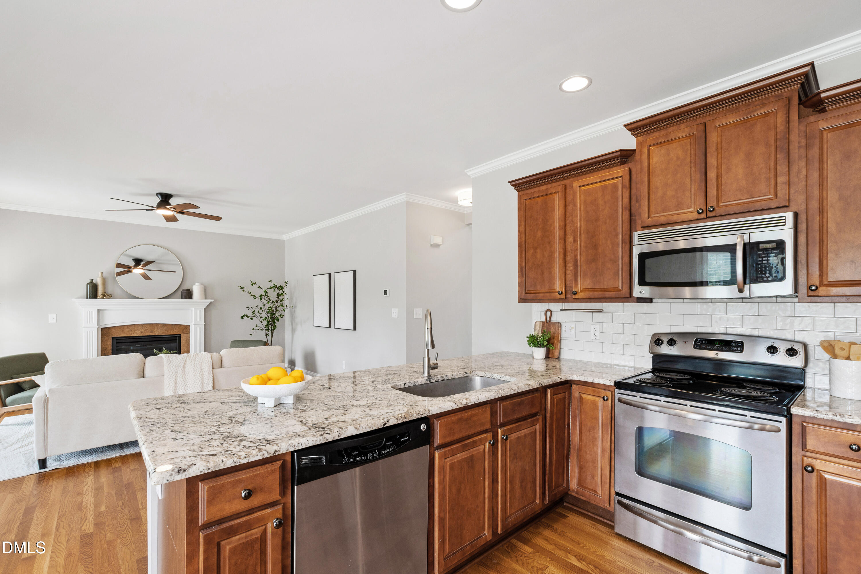 7753 Pegram Street Willow Spring, NC 27592 - Photo 16 of 54 a kitchen with stainless steel appliances granite countertop a sink stove and microwave