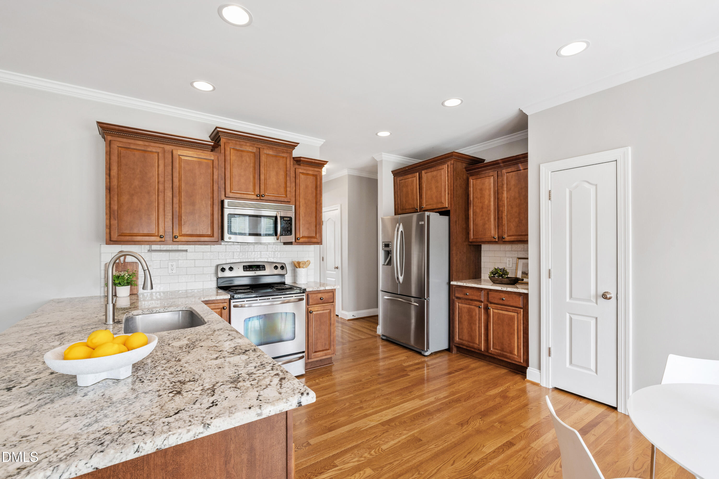 7753 Pegram Street Willow Spring, NC 27592 - Photo 17 of 54 a kitchen with stainless steel appliances granite countertop a refrigerator stove top oven a sink and dishwasher