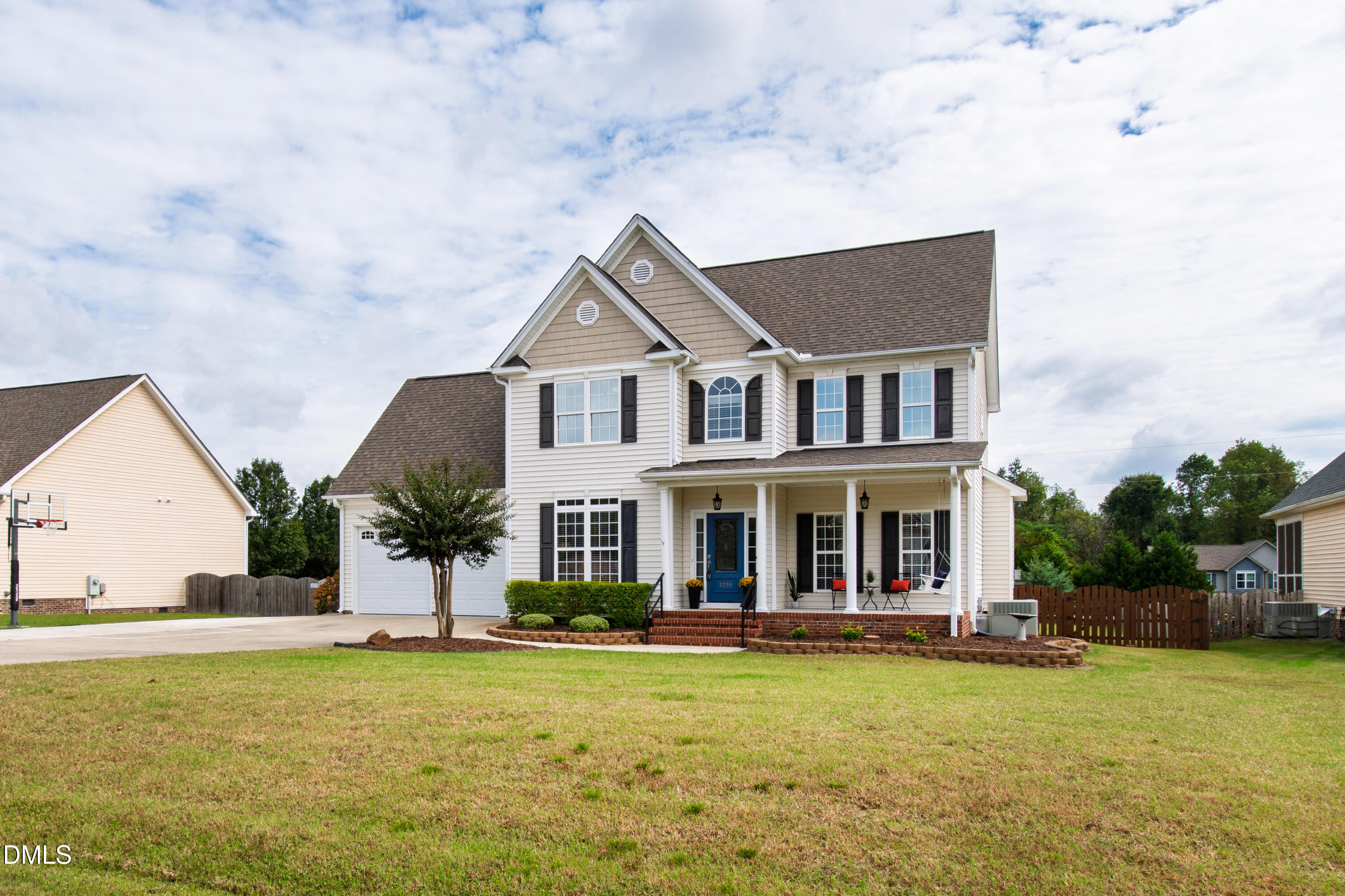 7753 Pegram Street Willow Spring, NC 27592 - Photo 2 of 54 a front view of a house with swimming pool and porch