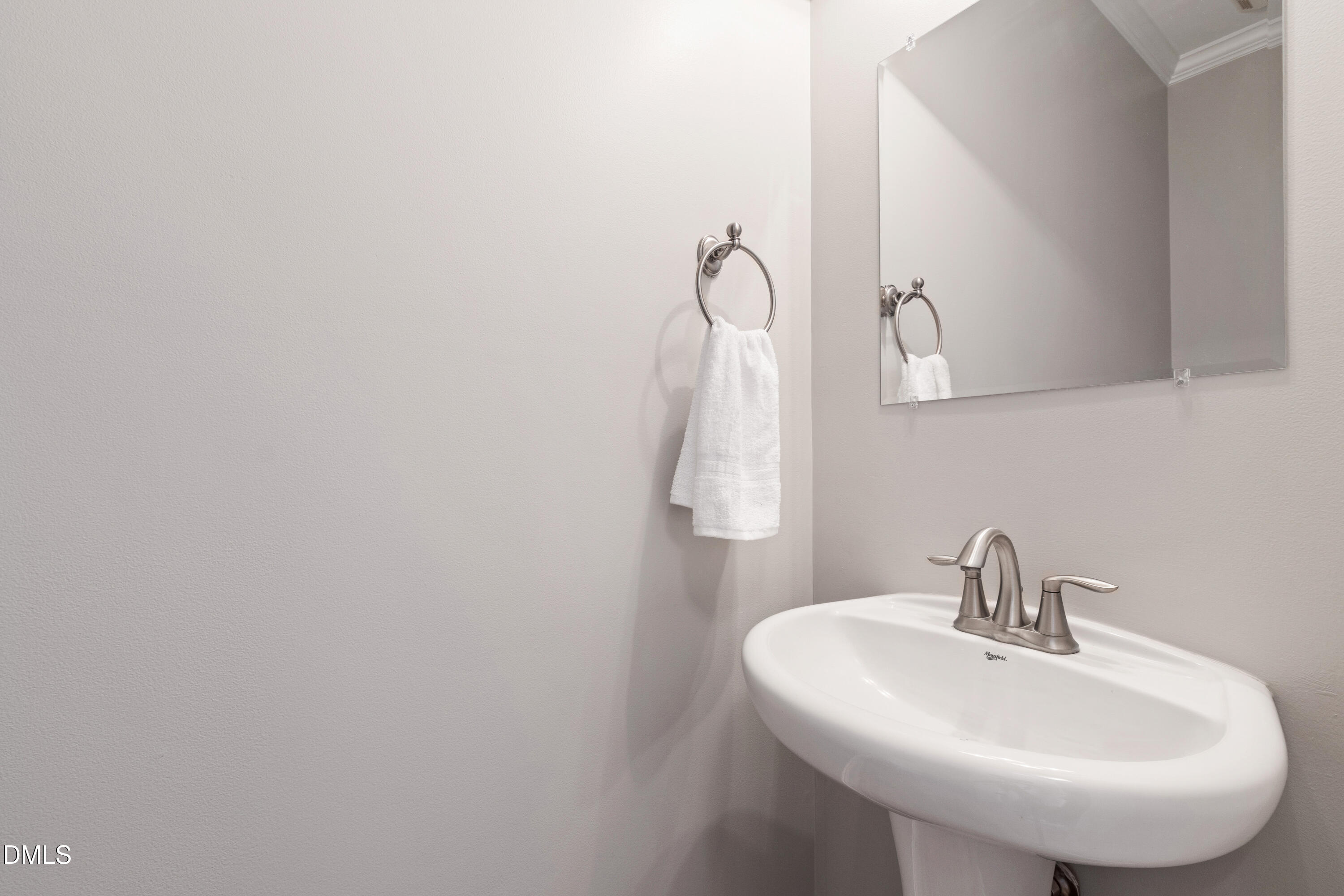 7753 Pegram Street Willow Spring, NC 27592 - Photo 26 of 54 a bathroom with a sink and mirror