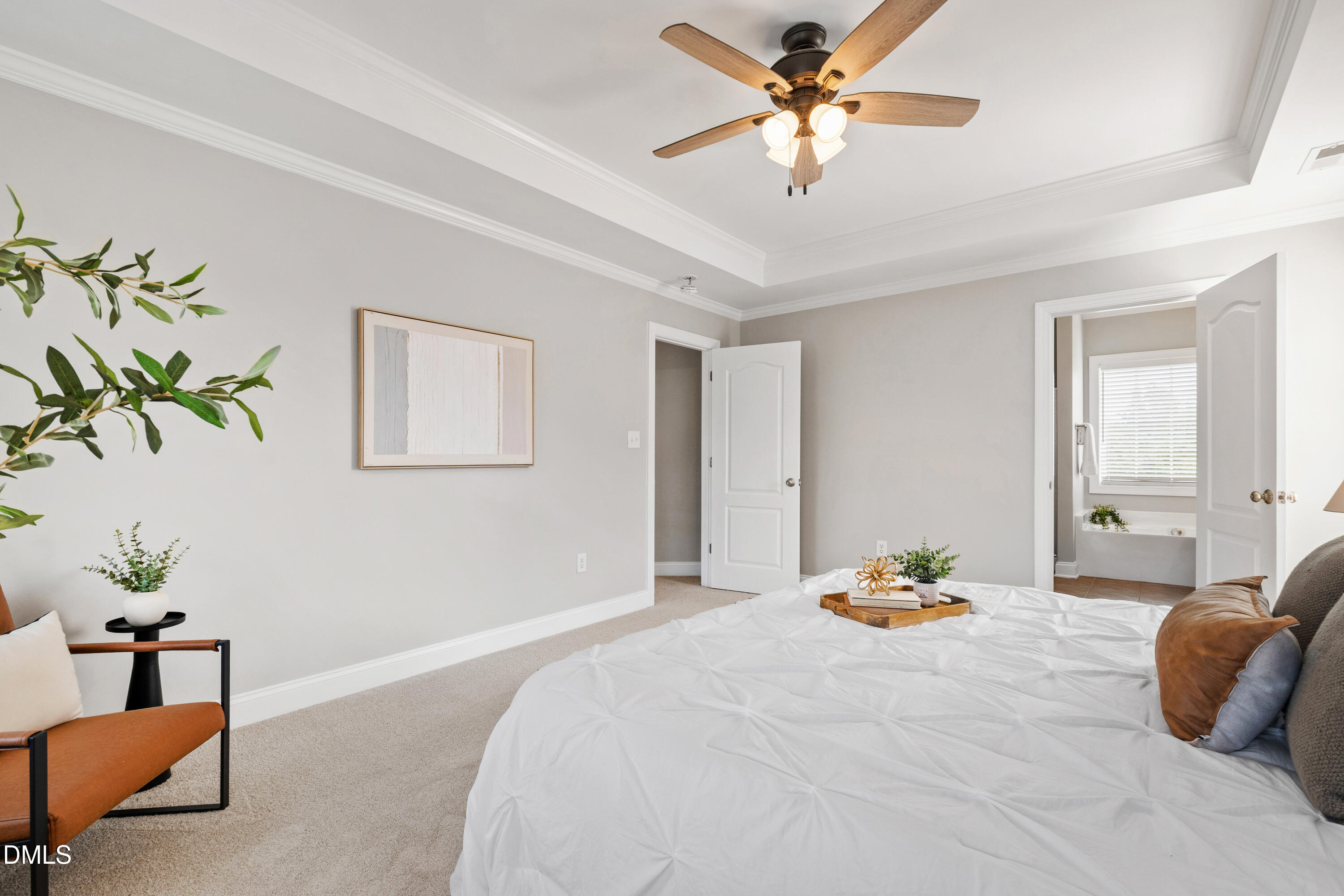 7753 Pegram Street Willow Spring, NC 27592 - Photo 30 of 54 a bedroom with a bed potted plant with the potted plants