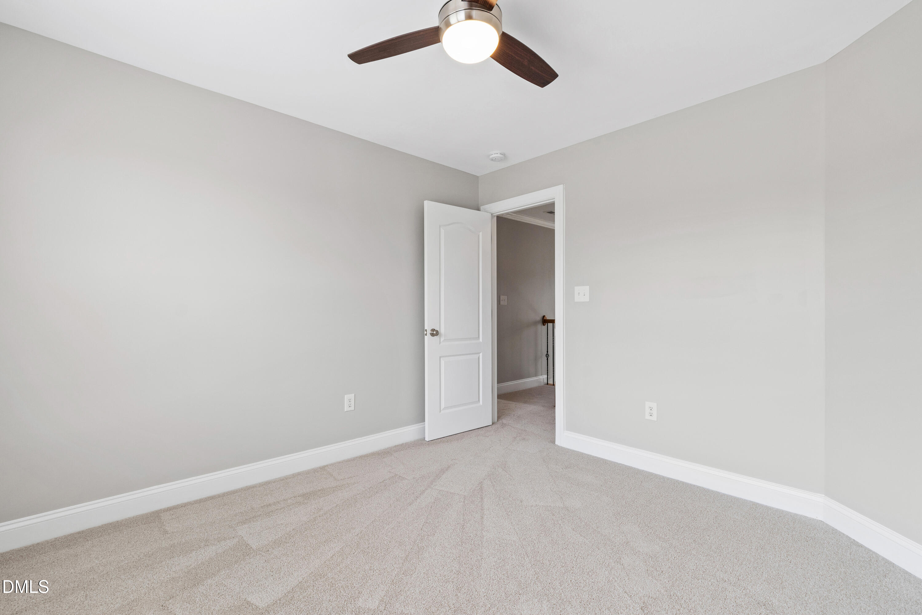 7753 Pegram Street Willow Spring, NC 27592 - Photo 36 of 54 an empty room with a ceiling fan and carpet