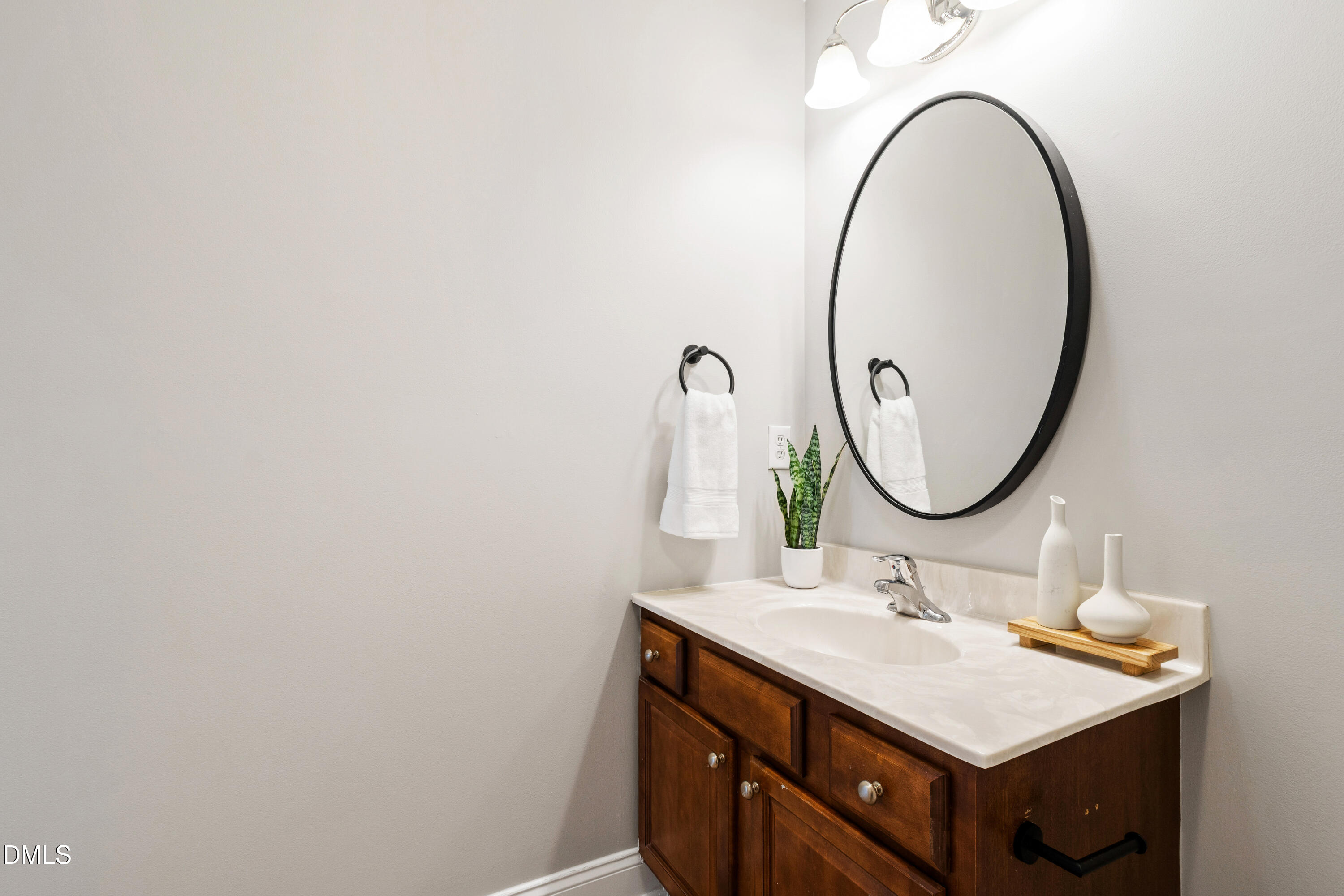 7753 Pegram Street Willow Spring, NC 27592 - Photo 38 of 54 a bathroom with a sink and a mirror