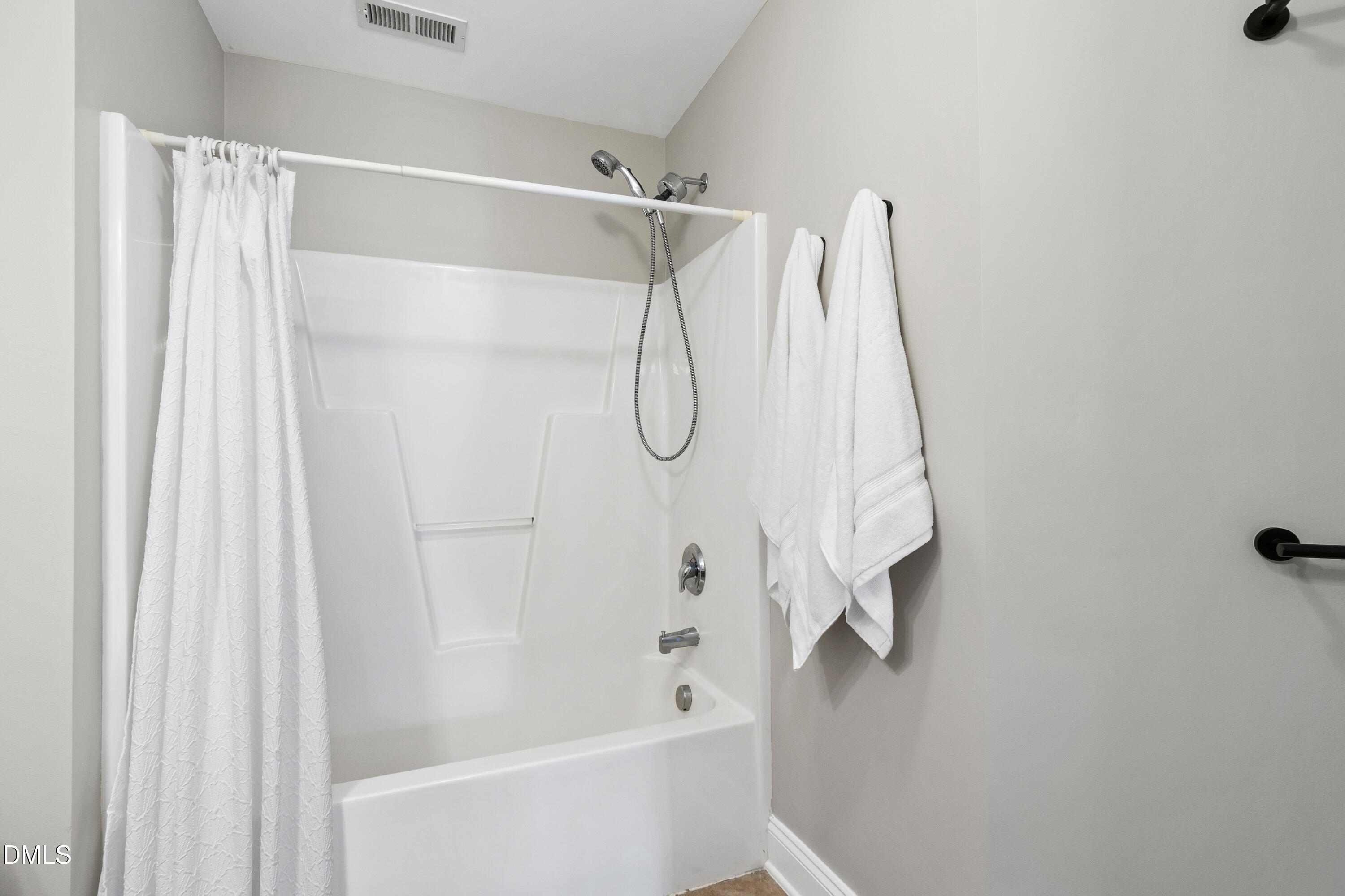 7753 Pegram Street Willow Spring, NC 27592 - Photo 39 of 54 a bathroom with a glass shower door