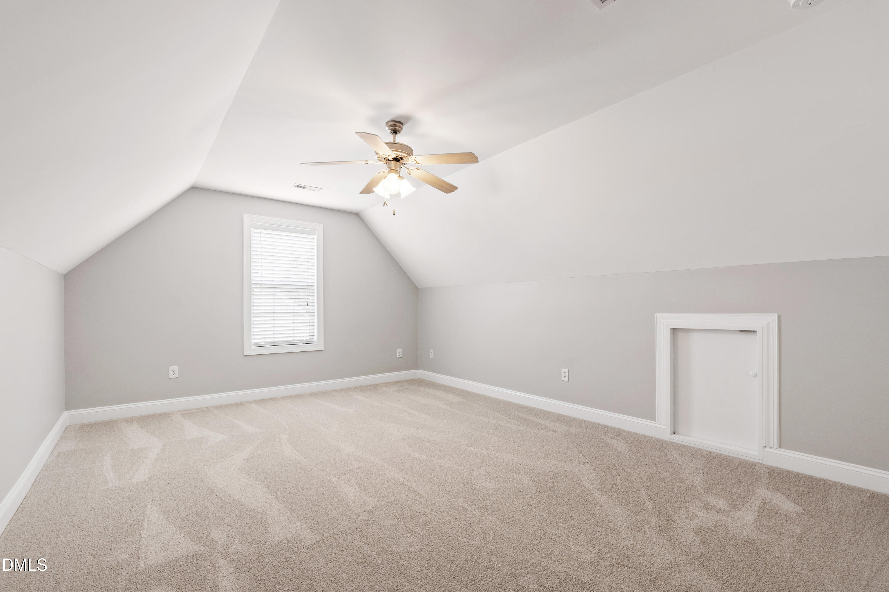 7753 Pegram Street Willow Spring, NC 27592 - Photo 44 of 54 an empty room with windows and chandelier fan
