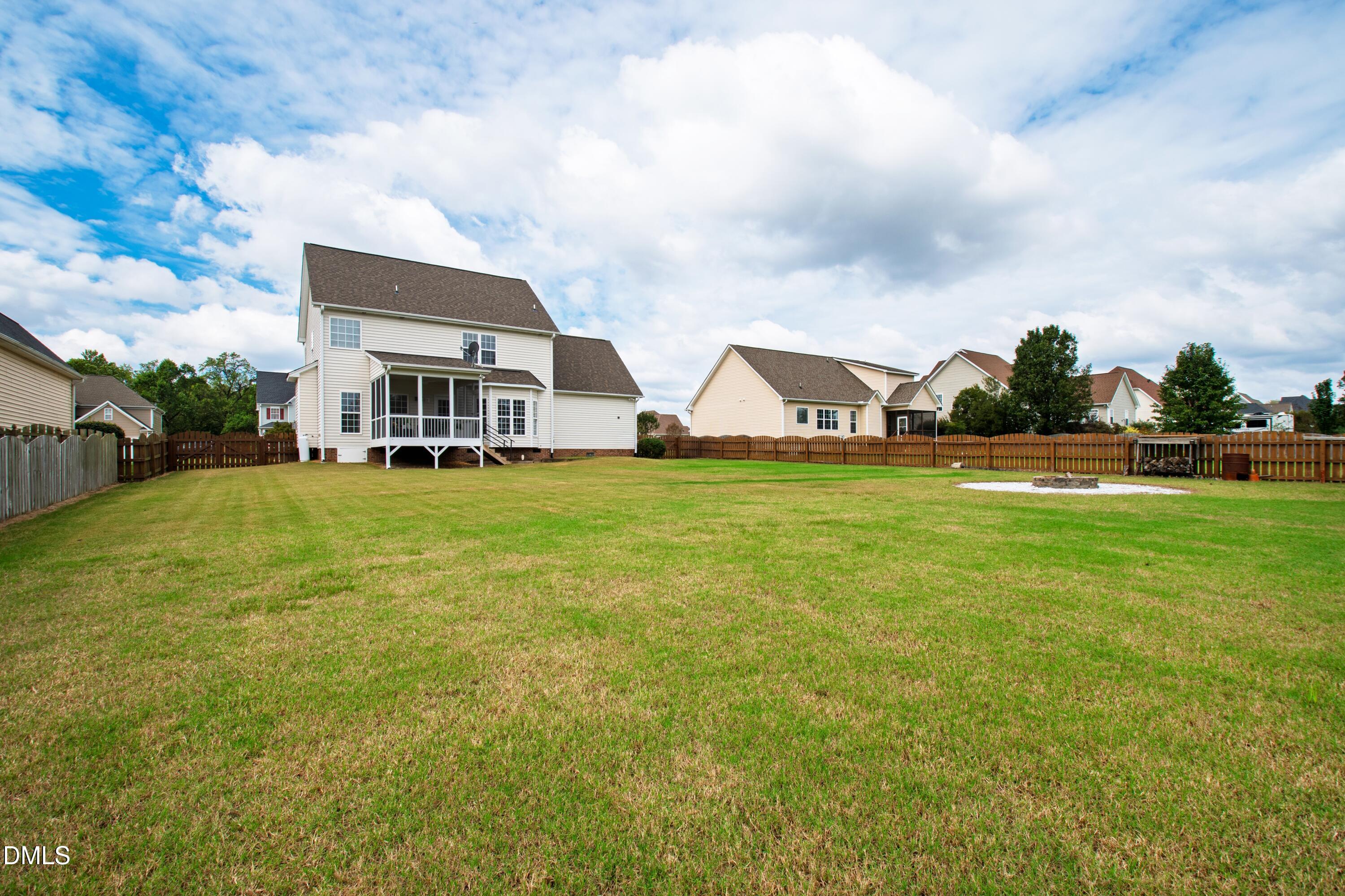 7753 Pegram Street Willow Spring, NC 27592 - Photo 48 of 54 a view of a house with a big yard and large trees