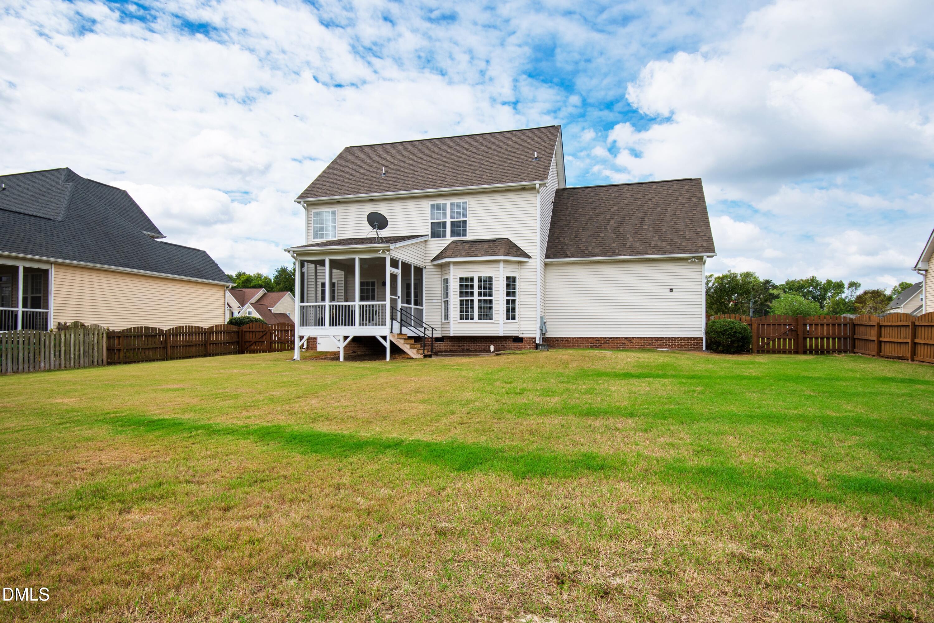 7753 Pegram Street Willow Spring, NC 27592 - Photo 49 of 54 a front view of house with yard and lake